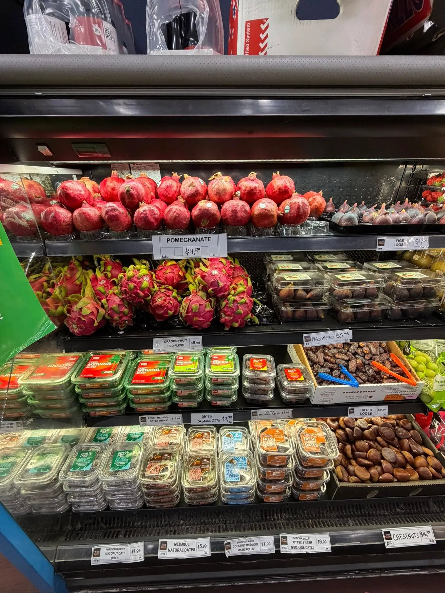 Red apples and green grapes with fresh sample container on display