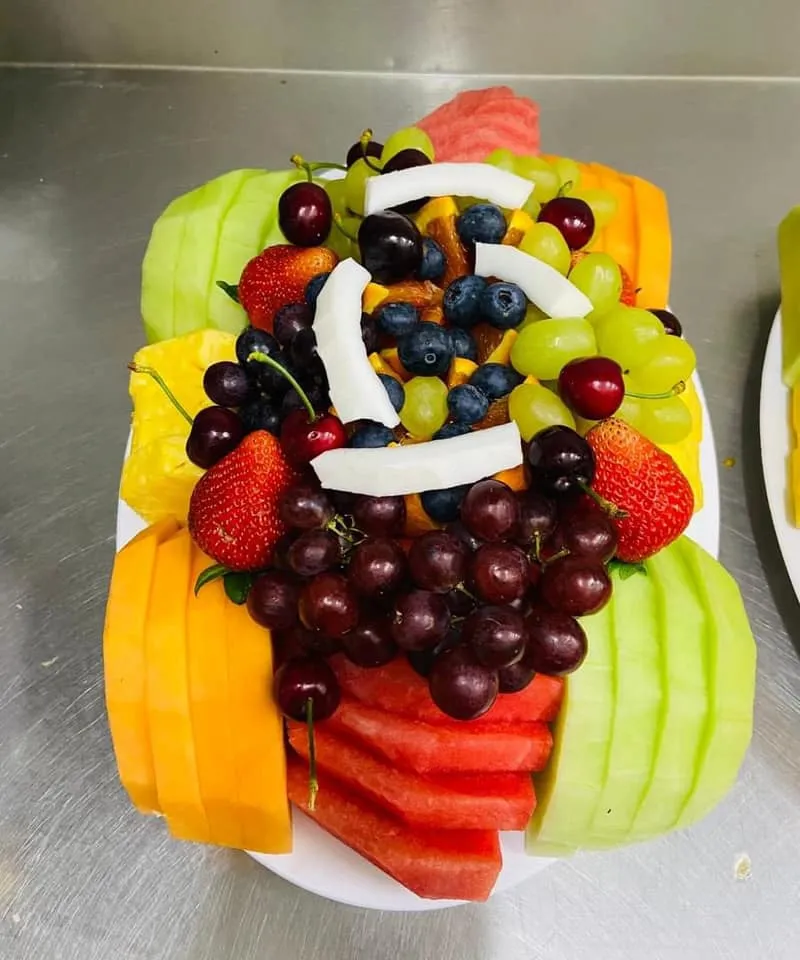 Mixed fruit salad tray with strawberries, melon, pineapple and grapes
