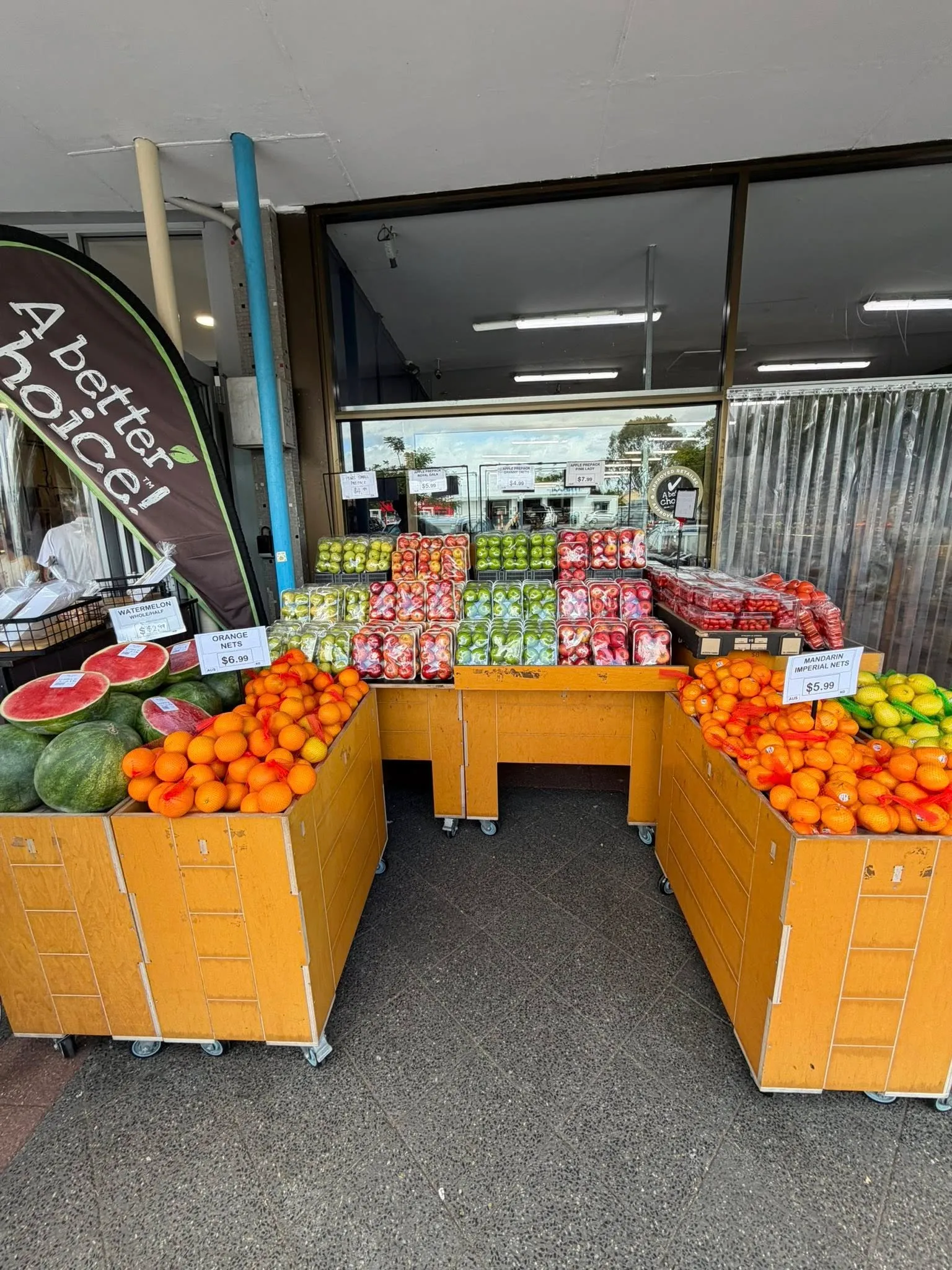 The Fruit Basket entrance with wooden produce boxes under the awning