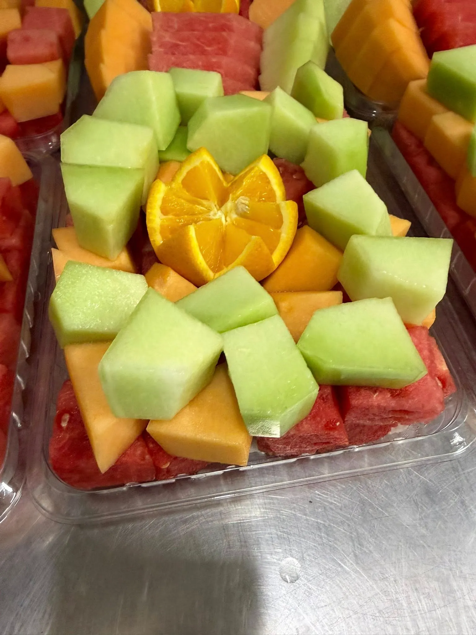Cantaloupe and watermelon cut fruit platter ready for collection